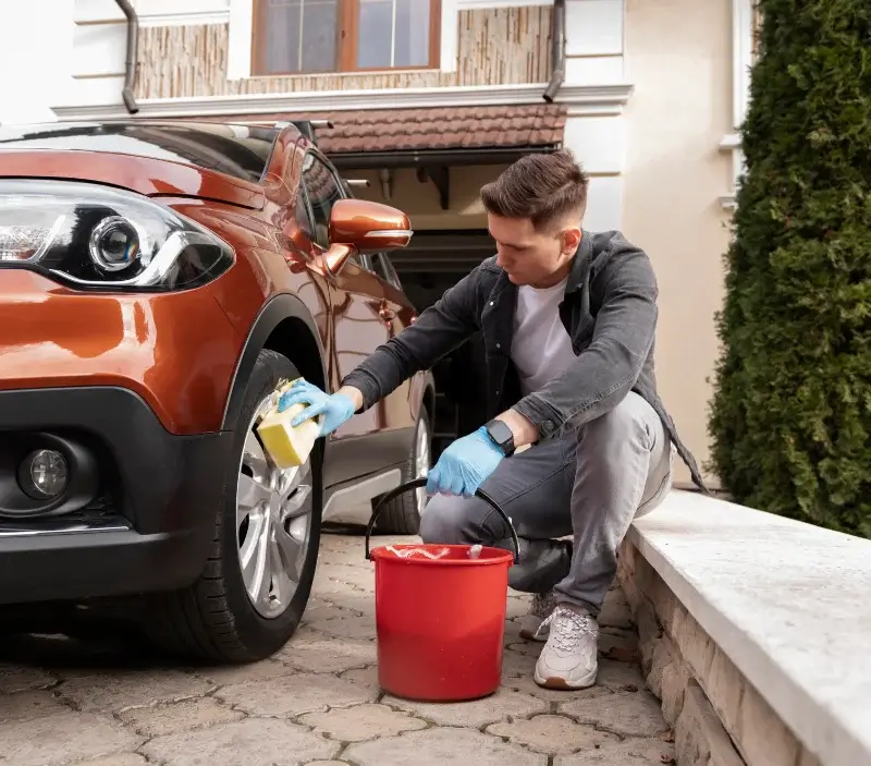 Lavage auto à domicile Milizac-Guipronvel : professionnel intervenant sur un véhicule
